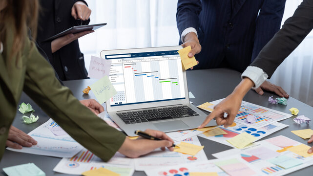 Analyst team use sticky note for creative and analytic brainstorm for business idea with BI data dashboard on laptop screen. Analysis financial data visualization tech for marketing strategy. Prodigy