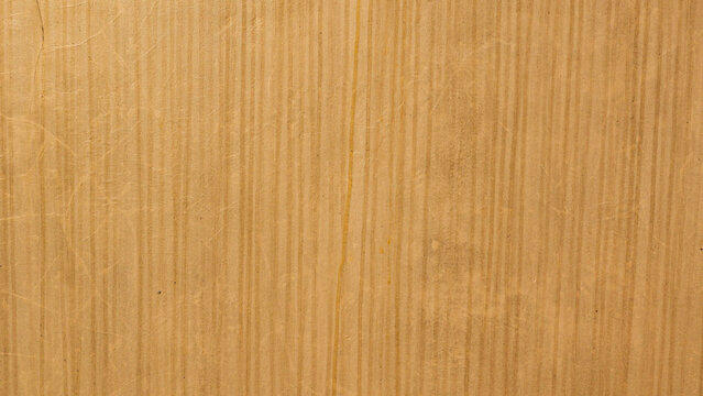 A textured brown wall featuring subtle vertical streaks, showing faint water drip marks running down its surface. 