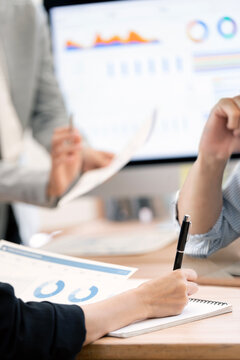 Close Up Businessperson Writing Notes and Analyzing Financial Data in Vertical Framing