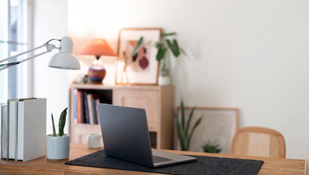 Cozy Home Office Workspace with Laptop Desk Lamp and Copy Space