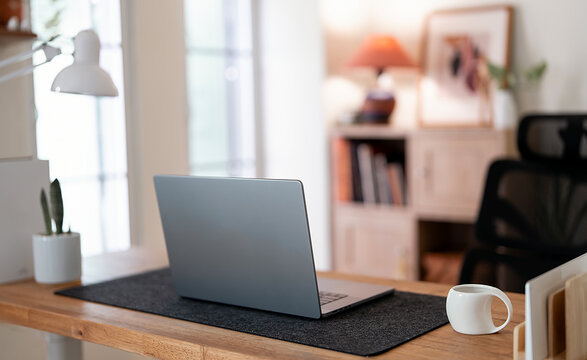 Modern Home Office Workspace with Laptop Coffee Cup and Desk Lamp
