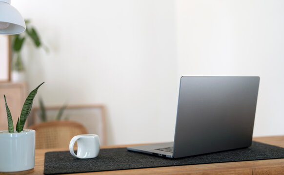 Laptop Computer on Wooden Desk in Minimalist Home Office Workspace
