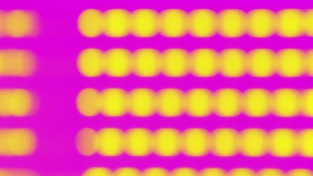 Horizontal defocused video banner. Loop animation. Abstract blurred round yellow lights bokeh pattern forming grid structure on pink background. Glowing illumination design backdrop for screensaver