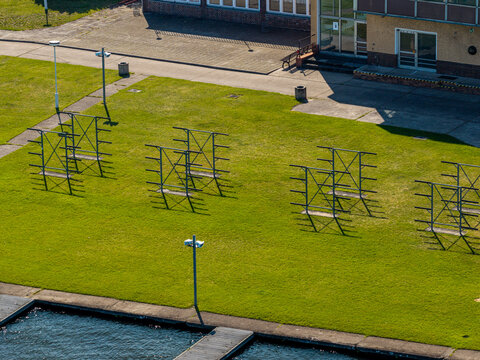 Aerial view of the Berlin-Grunau Regatta Course featuring metal boat racks on a green lawn near the water in Berlin, Berlin, Germany.