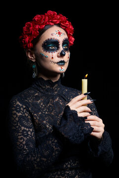 Halloween beauty portrait of woman. Beautiful female face adorned with Santa Muerte makeup.