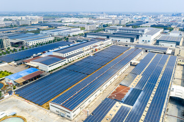 Industrial park rooftops covered with large arrays of solar panels for green energy generation © zhangyang135769