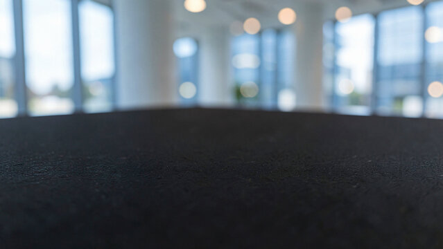 Matte Black Slate Table Surface on Modern Penthouse Balcony Bar with Glass Railings Luxury City Boke
