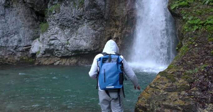 Boy explores some Dolomite waterfalls.