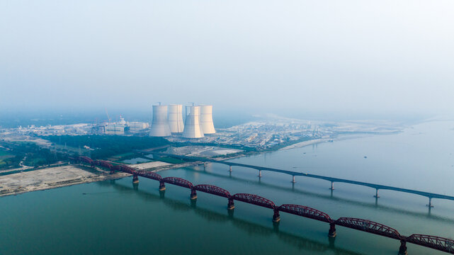 Aerial view of the Rooppur Nuclear Power Plant with its large cooling towers situated near the historic Hardinge Bridge over the Padma River in Pabna, Rajshahi Division, Bangladesh.