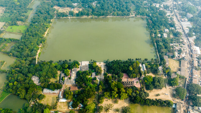 Aerial view of Bagha Shahi Mosque and its large historic pond surrounded by lush greenery and rural landscape in Rajshahi, Rajshahi Division, Bangladesh.