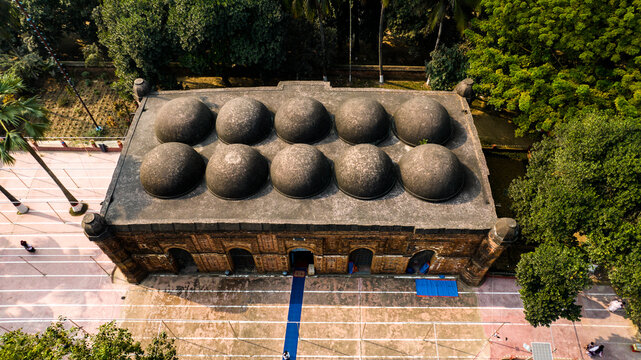 Aerial view of Bagha Shahi Mosque with its distinctive ten domes and terracotta brick architecture surrounded by lush trees, Rajshahi, Rajshahi Division, Bangladesh.