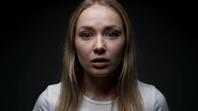 Blonde woman's surprised expression close-up, shocked expression close-up shot