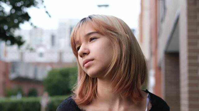 Thoughtful teenage girl looking upward, searching for confidence, meaning, and emotional orientation in a school age moment