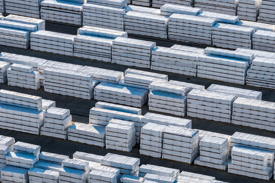 Aerial view of stacks of white-wrapped industrial materials arranged in rows at an industrial site in Nera Montoro, Umbria, Italy.