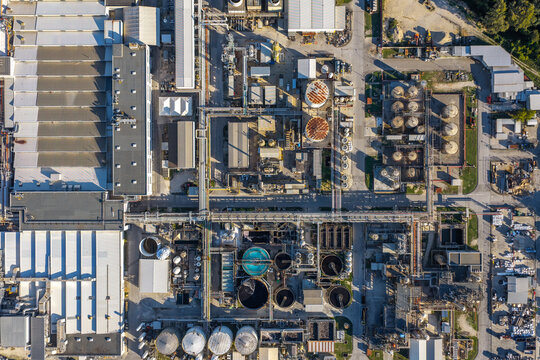 Aerial view of an industrial plant with large factory buildings, storage tanks, and complex pipeline networks in Nera Montoro, Umbria, Italy.