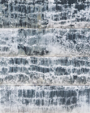 Aerial view of weathered rooftop texture with white streaks on a dark surface in Taiwan.