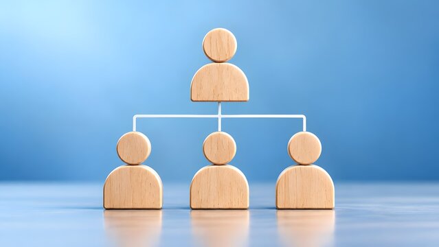 Wooden figures representing a hierarchical organizational structure or team hierarchy symbolizing management and employees on a blue background.