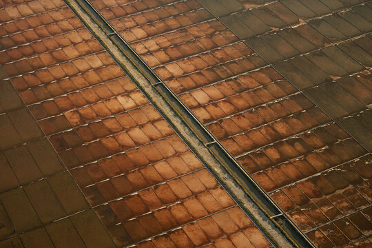 Aerial view of salt pans with rectangular evaporation ponds and narrow walkways in Rio de Janeiro, Rio de Janeiro, Brazil.