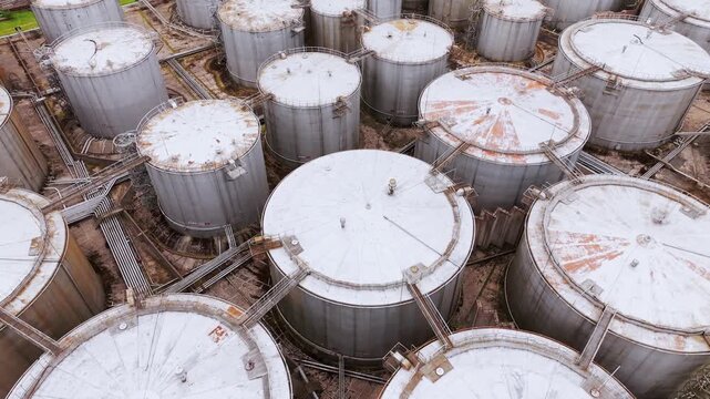 Industrial oil storage tanks at fuel depot viewed from aerial perspective.