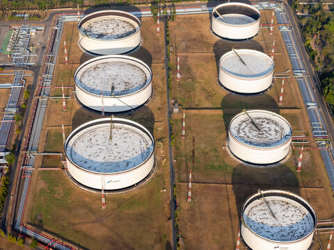 Aerial view of large white oil storage tanks at the Pertamina refinery facility in Cilacap, Central Java, Indonesia.