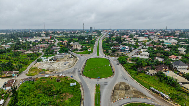Aerial view of a large roundabout with a central green island in the urban landscape of Uyo, Akwa Ibom, Nigeria.