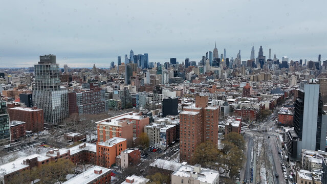 Aerial view of the Manhattan skyline in winter with snow-covered rooftops and dense urban architecture in New York, New York, United States.