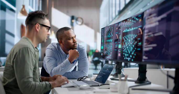 Data Scientist Carefully Analyzes AI Models Using Laptop