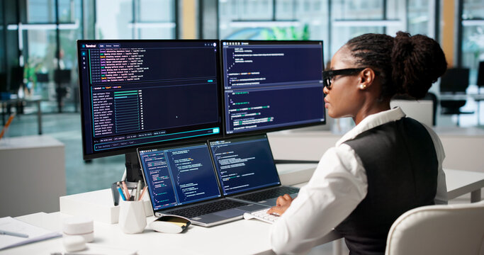 Software Developer Carefully Writing Code On Laptop