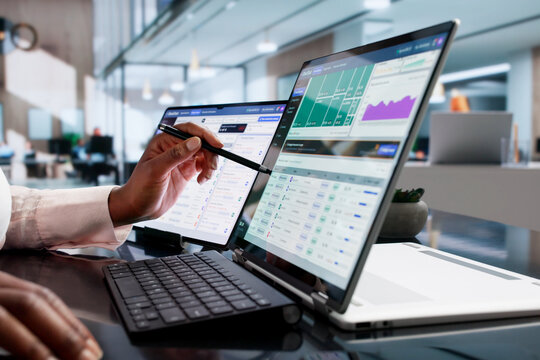 Financial Analyst Studies Cloud Spend Data On Laptop