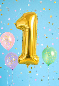 Golden Number One Balloon Surrounded By Colorful Balloons And Confetti