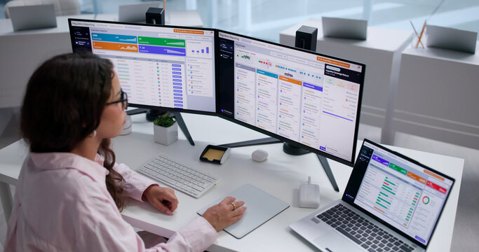 Financial Analyst Carefully Reviews Banking Reports On Laptop