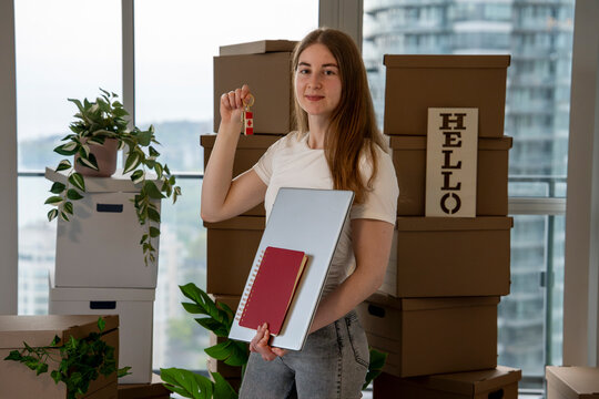 Newcomer Holding Canadian Key After Moving to a New Home