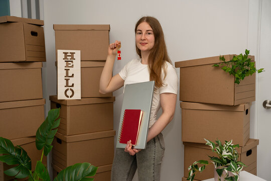 Newcomer Holding Canadian House Key Among Moving Boxes