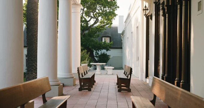 College, empty or campus with outdoor bench, tertiary institution or chairs in learning environment. Education, vacant or student building with seats, architecture or academic faculty in university.