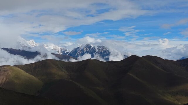 4K Aerial View of Rolling Cloud Sea Over Tibetan Snow Mountains and Grasslands
