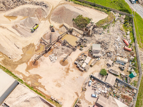 Aerial view of the sand and gravel quarry in Philippi with industrial processing equipment, conveyor belts, and piles of sand in Cape Town, Western Cape, South Africa.