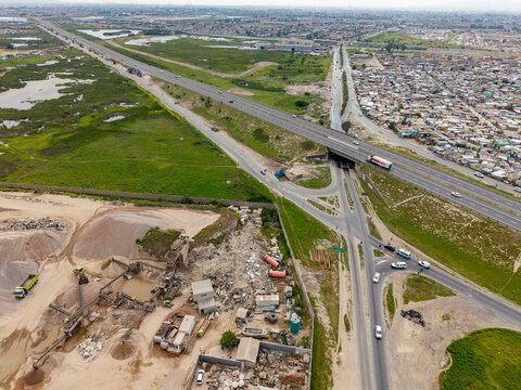 Aerial view of the highway interchange and industrial quarry site adjacent to residential areas in Philippi, Cape Town, Western Cape, South Africa.