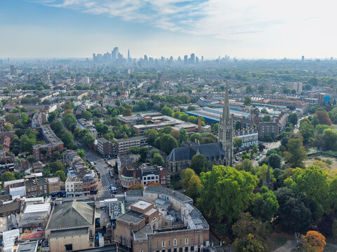 Aerial view of Stoke Newington featuring St Mary's Church, surrounding residential streets, lush trees, and the distant London skyline in London, England, United Kingdom.