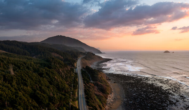 Aerial view of Humbug Mountain and Highway 101 along the rugged Oregon Coast at sunset in Curry County, Oregon, United States.
