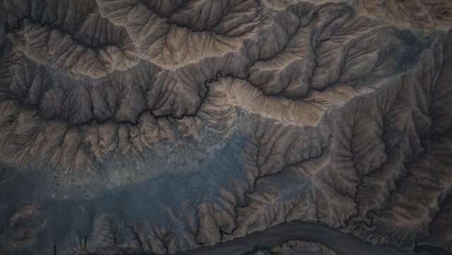 Aerial view of the rugged, eroded landscape and deep ravines near Issyk Kul in the Issyk-Kul Region, Kyrgyzstan.