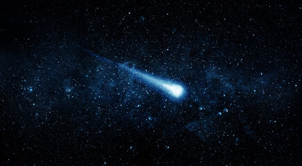 Comet, asteroid, meteorite flying on the background of the starry night sky. Glowing asteroid and tail of a falling comet. Elements of this image furnished by NASA. © Tryfonov
