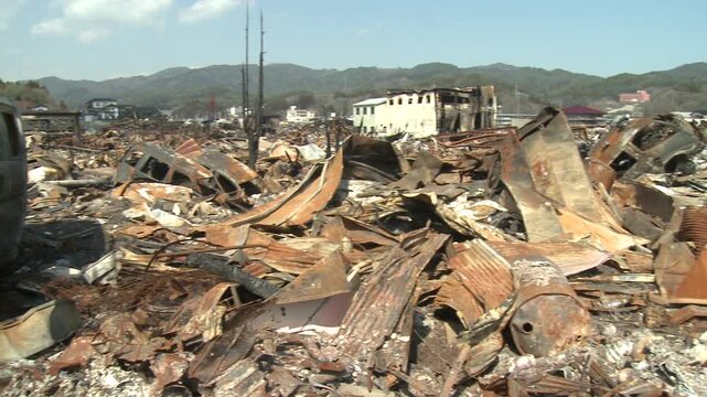 Burnt Out Debris And Ship Washed Ashore In Aftermath Of Tsunami In Japan