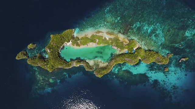 Breathtaking high angle panorama of Rufas Island coast in Raja Ampat Papua &ndash; Glowing golden hour sunset over beachfront homestay, coconut palms, shallow coral reef and turquoise ocean video 4k UHD