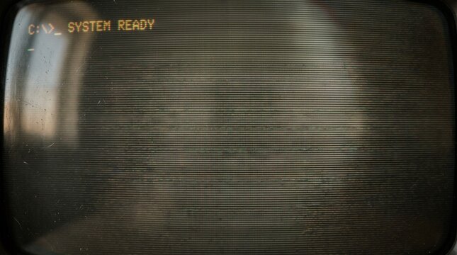Vintage Computer Terminal Display Screen Featuring A Retro Command Line Interface Showing System Ready Message In Dark Monochrome Tone