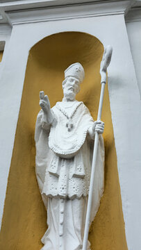 White Saint Statue in Yellow Niche. Nord Europe