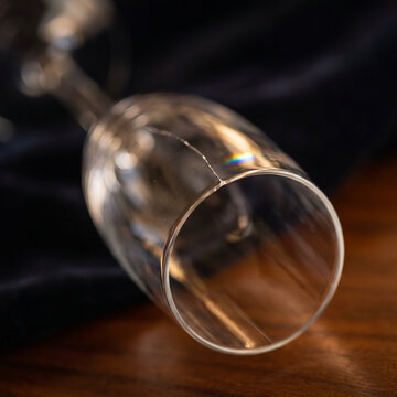 Clear glass champagne flute on a dark velvet surface  