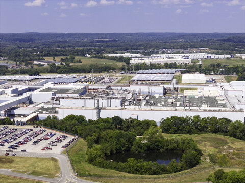 Aerial view of the General Motors Spring Hill Manufacturing Plant, showing industrial buildings, HVAC units, ventilation systems, parking lots, and green landscape in Nashville, TN, United States.
