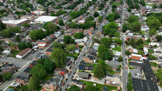 Aerial view of the residential neighborhood of South Lancaster with dense rows of brick houses, tree-lined streets, and urban infrastructure in Lancaster, Pennsylvania, United States.