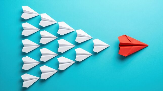 Leader red paper plane flying ahead of a formation of white paper planes on blue background with leadership