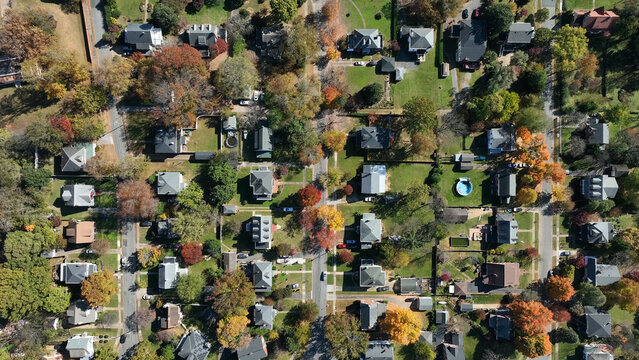 Aerial view of a residential neighborhood with houses, colorful autumn trees, and streets in Lynchburg, Virginia, United States.